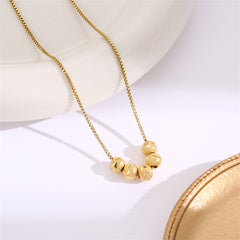 Stunning 18K gold-plated necklace adorned with four chic beads, a must-have accessory for a sophisticated look.
