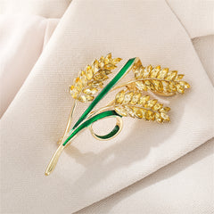 Charming yellow and green floral brooch with leaves, featuring exquisite 18K gold-plated crystal and green enamel details.