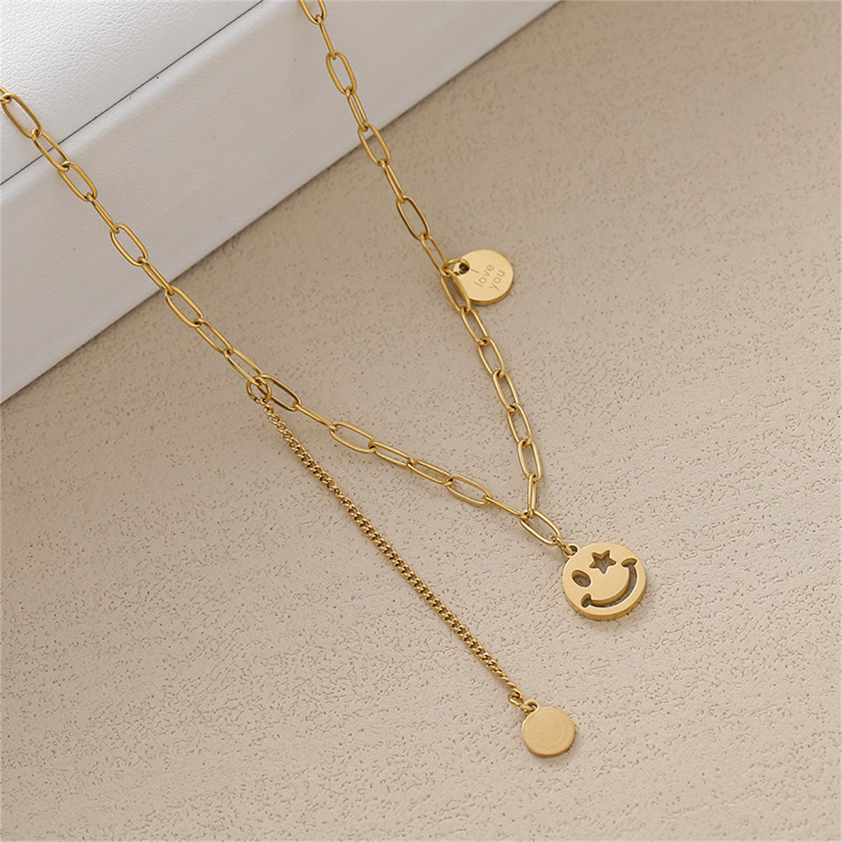 A charming smiley face necklace on a gold chain, beautifully crafted in 18K gold plating to spread joy and affection.