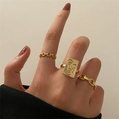 Three elegant gold-plated rings with initials, paired with a stylish chain, perfect for personalized fashion statements.