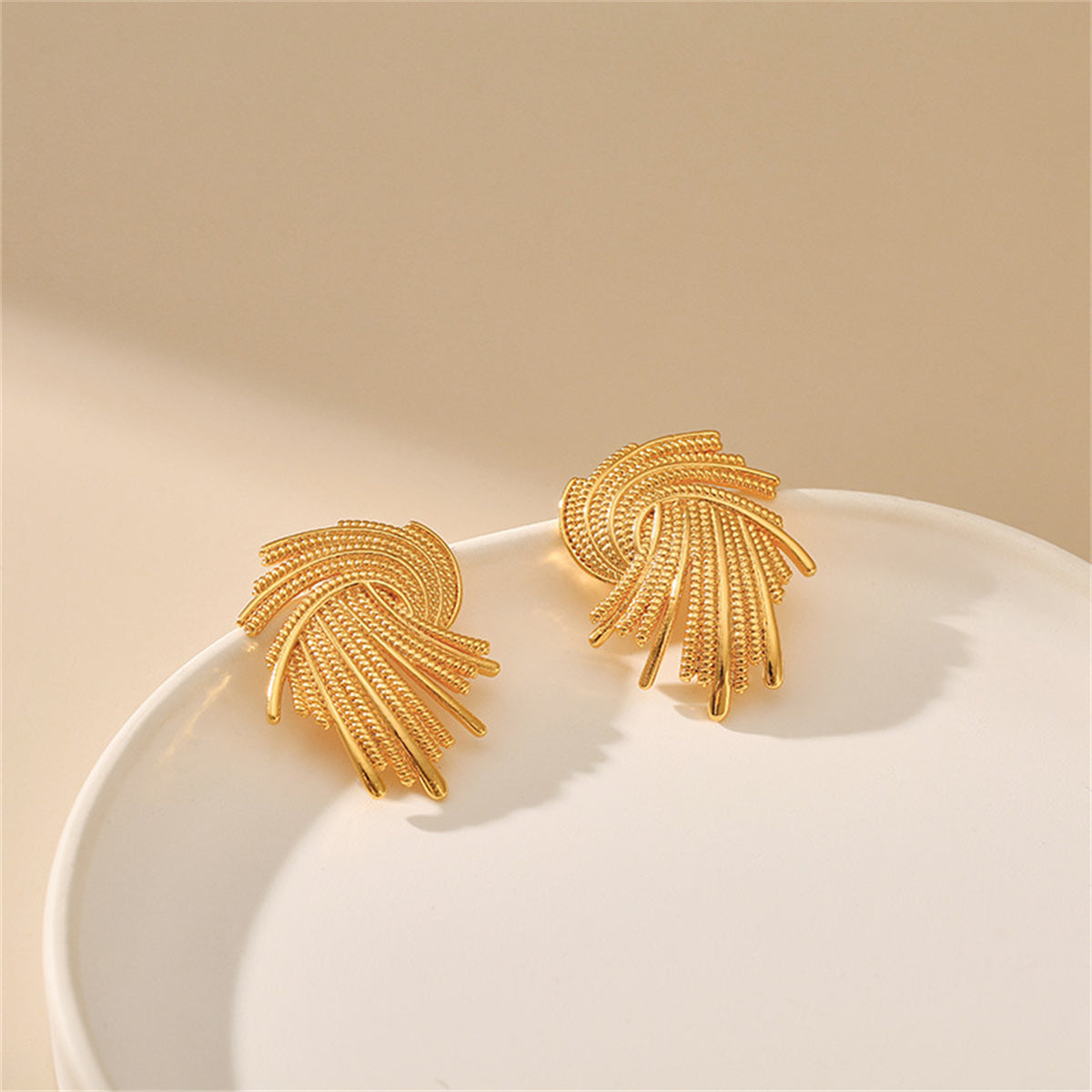 Stunning 18K gold-plated earrings with a unique twisted design, ideal for elevating your jewelry collection effortlessly.