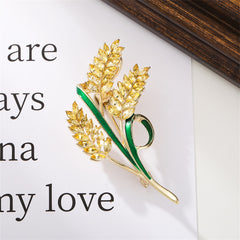 Beautiful yellow and green floral brooch with leaves, designed in 18K gold-plated crystal and green enamel.