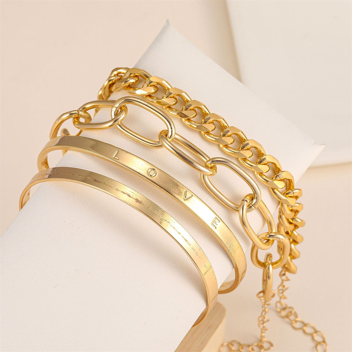 Exquisite 18K gold-plated 'Love' cuff set, featuring three stylish chain bracelets with a heart charm for added elegance.
