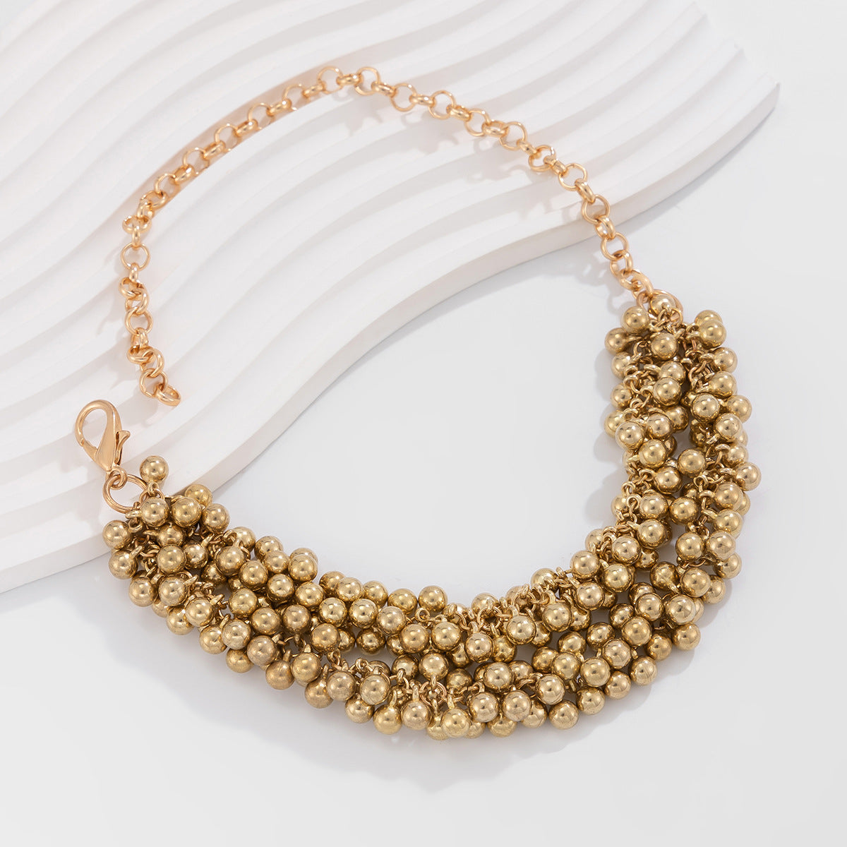 Dazzling 18K gold-plated necklace featuring two strands of gold beads, a perfect accessory for any stylish occasion.