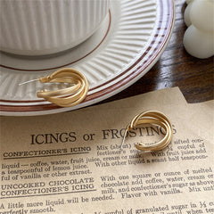 Eye-catching 18K gold-plated twisted hoop earrings, perfect for enhancing your jewelry collection with a modern flair.