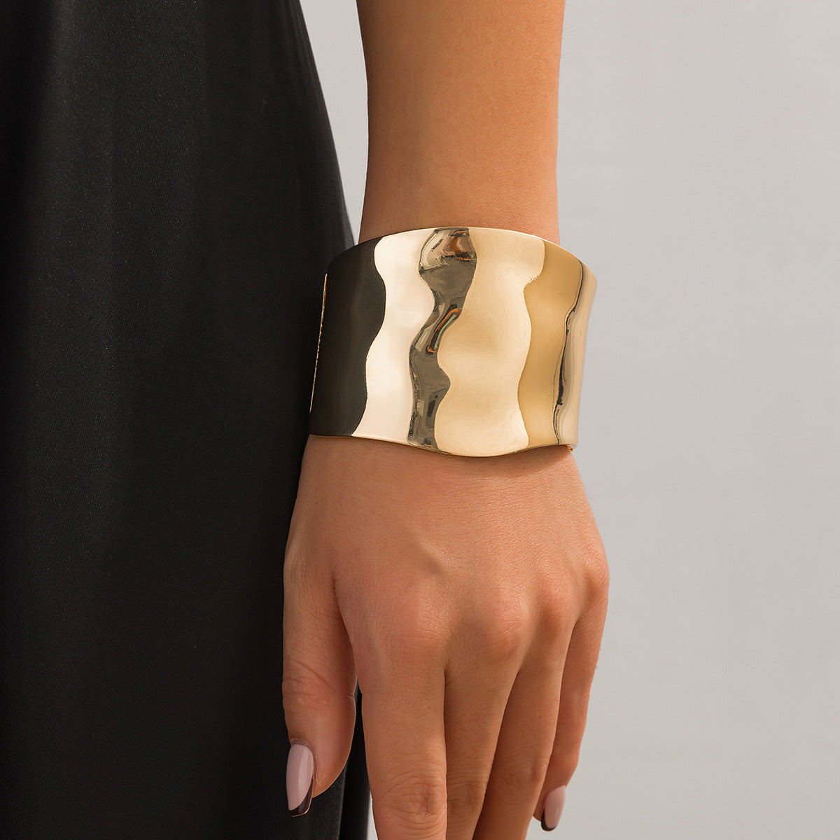 Elegant 18K gold-plated bangle bracelet featuring a sleek, curved design for a sophisticated touch to any outfit.