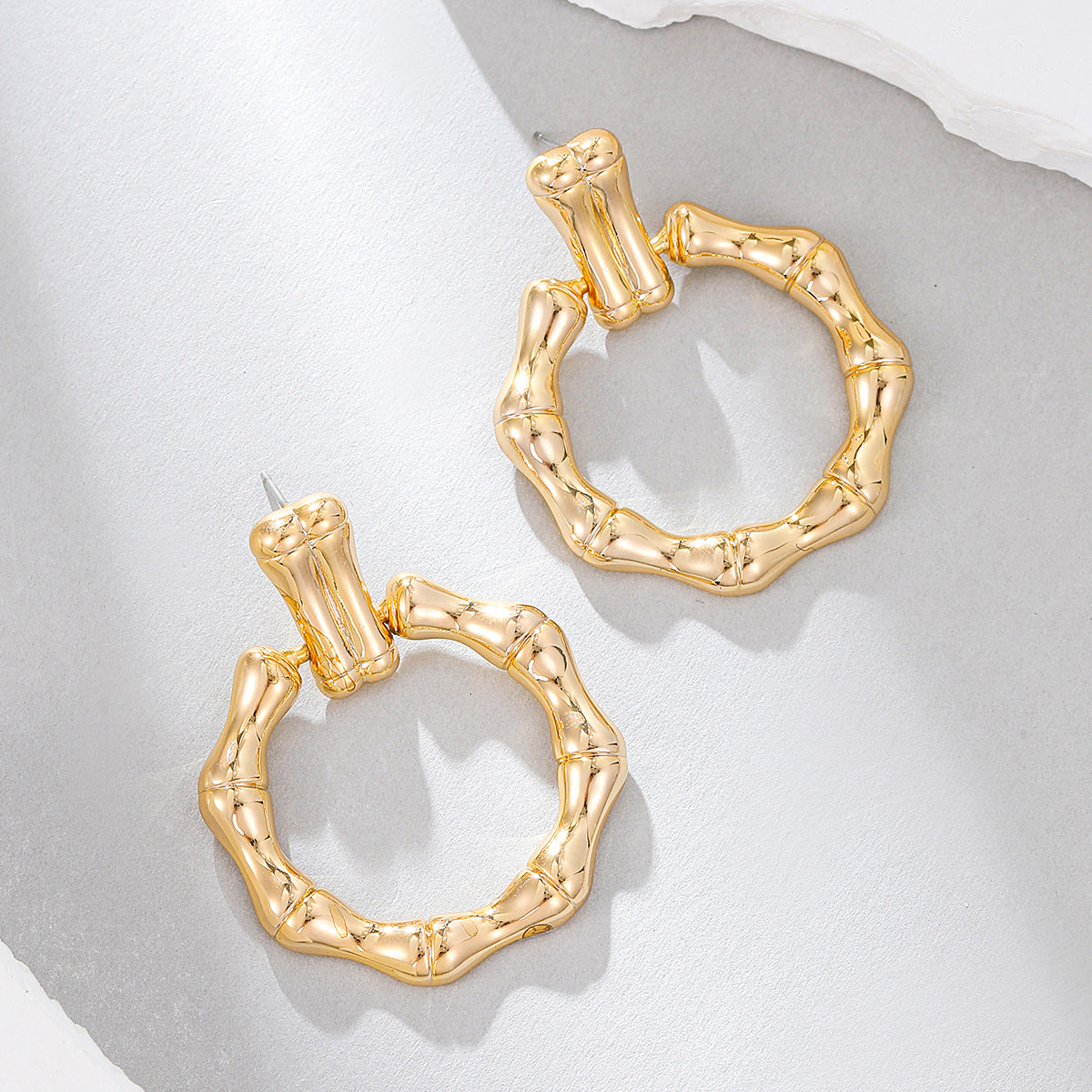 Beautiful 18K gold-plated bamboo earrings, designed in a circle drop style, ideal for elevating your accessory game.