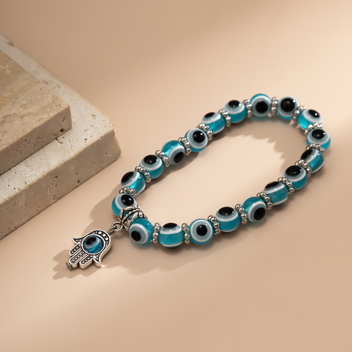 Sea Blue Acrylic and Silver-Plated Evil Eye Hamsa Charm Bracelet, silver bracelet for women, everyday style, detail close-up