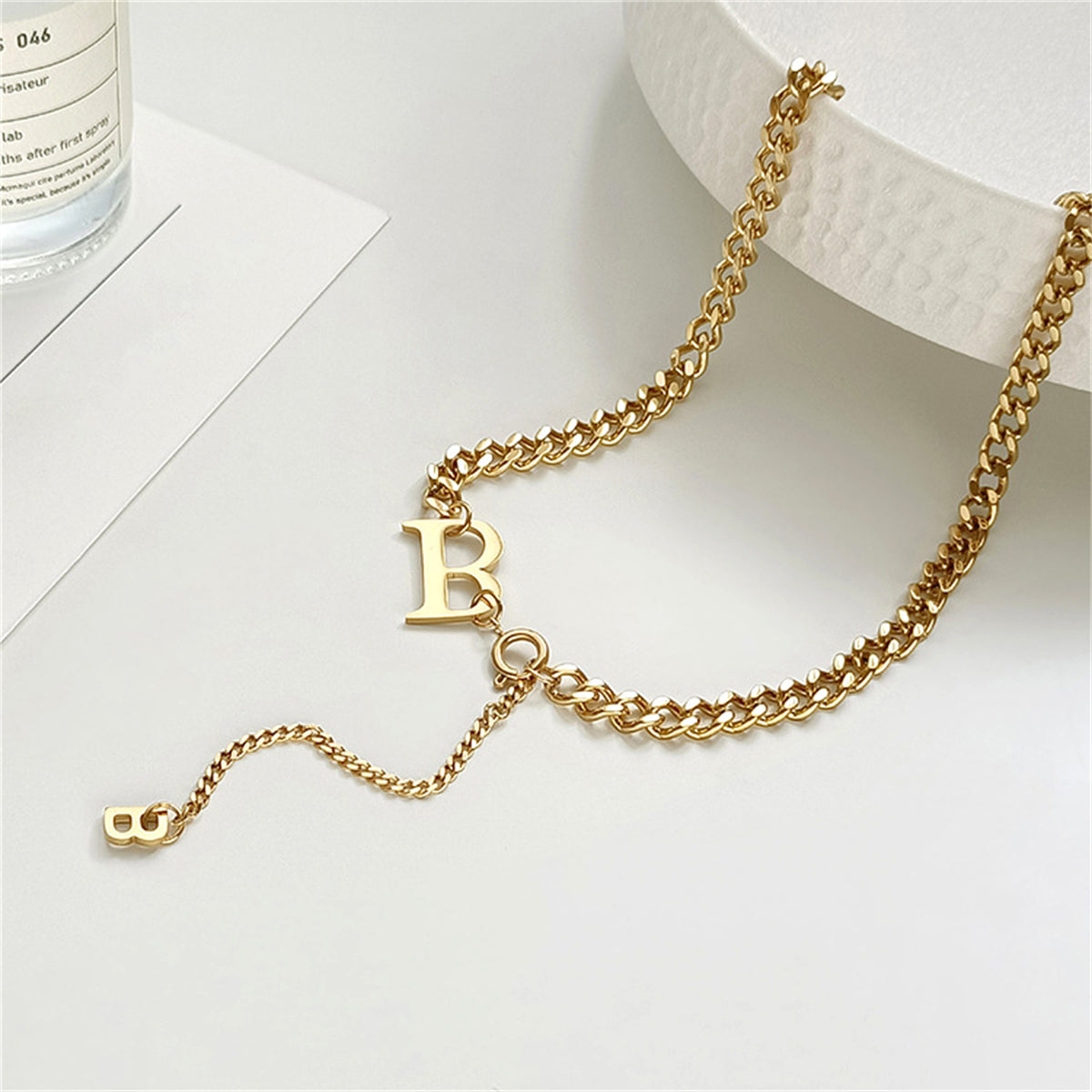 Elegant 18K gold-plated necklace featuring a 'B' charm and a heart, perfect for adding a personal touch to any outfit.