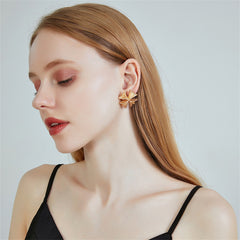 Dazzling 18K gold-plated clover stud earrings with a stylish gold cross, a must-have accessory for your jewelry collection.
