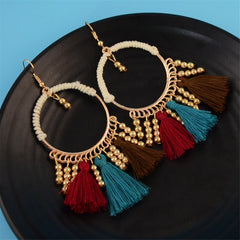 Elegant 18K gold-plated hoop earrings adorned with vibrant multi-colored tassels for a chic, eye-catching look.