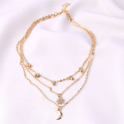 Cubic Zirconia and 18K Gold-Plated Stars Moon Layered Necklace, gold pendant necklace for women, detail close-up