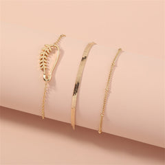 A stunning set of three gold bracelets with a delicate chain and leaf charm, showcasing 18K gold-plated craftsmanship.