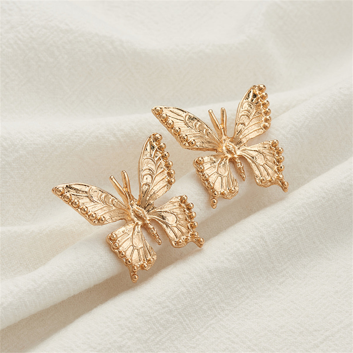Beautifully crafted 18K gold-plated butterfly earrings embellished with tiny diamonds, a perfect accessory for any occasion.