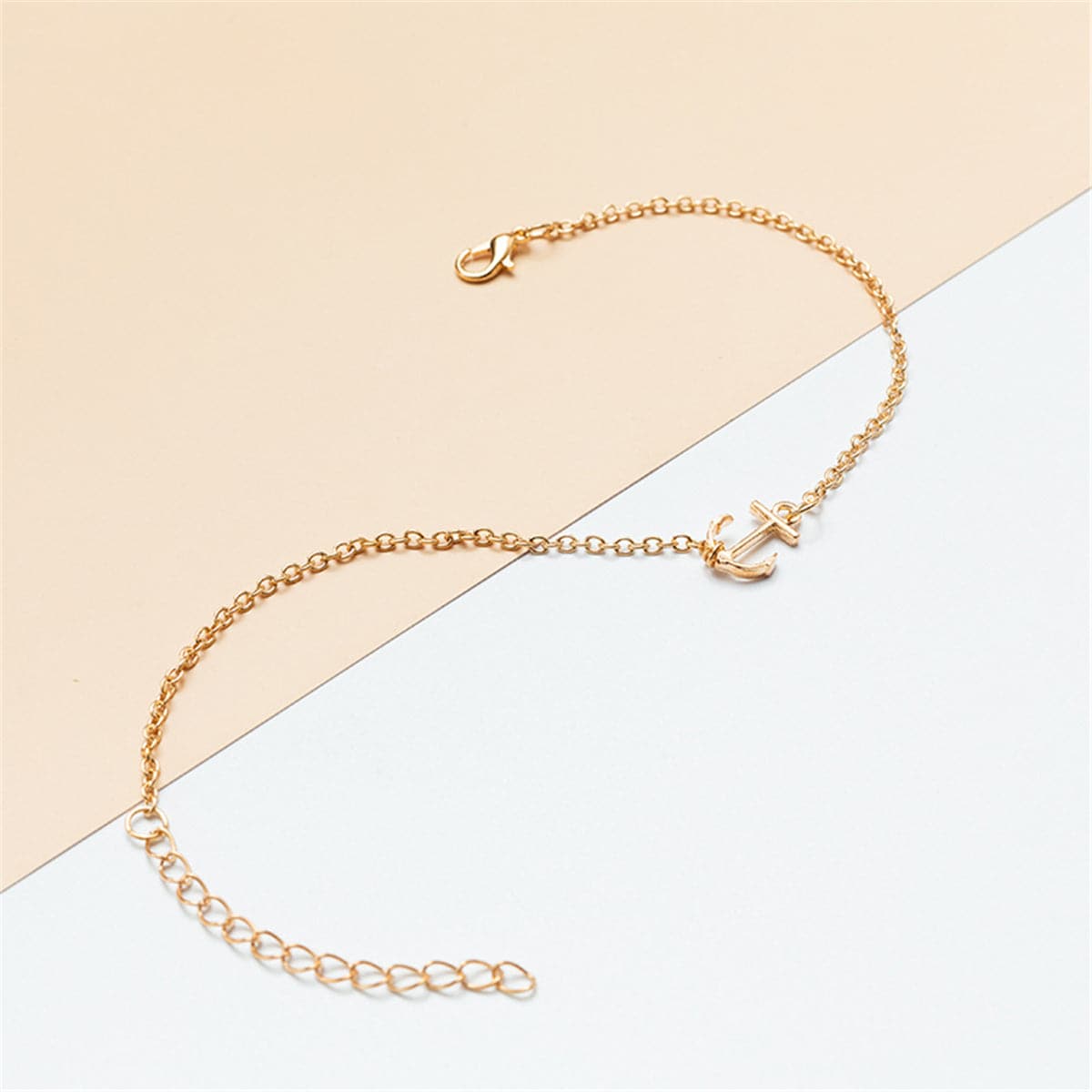 Beautiful gold chain anklet adorned with a small anchor charm, designed in 18K gold plating for a stylish look.
