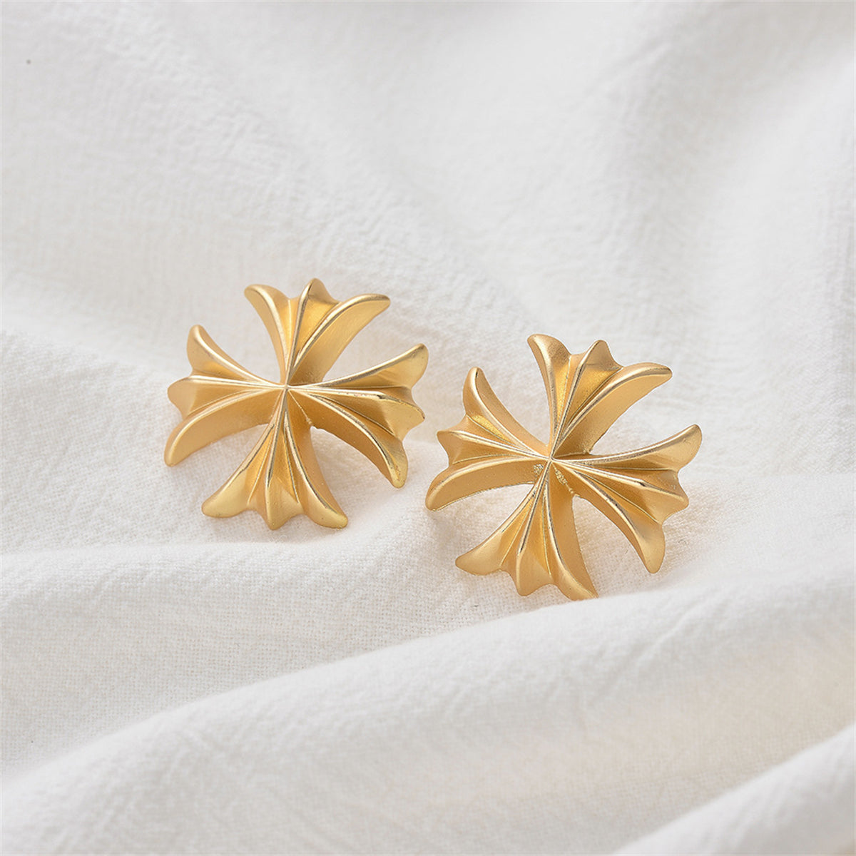 Beautifully designed 18K gold-plated clover stud earrings with a gold cross, perfect for enhancing your style effortlessly.