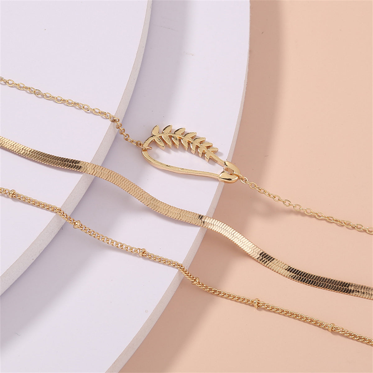 Elegant 18K gold-plated bracelet set featuring three pieces with a chain and a charming leaf, ideal for stylish accessorizing.