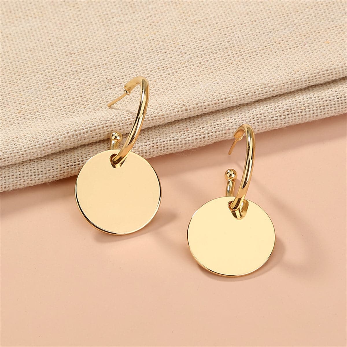Beautiful 18K gold-plated circle huggie earrings, designed with a sleek circle and a small disc for a trendy accessory.