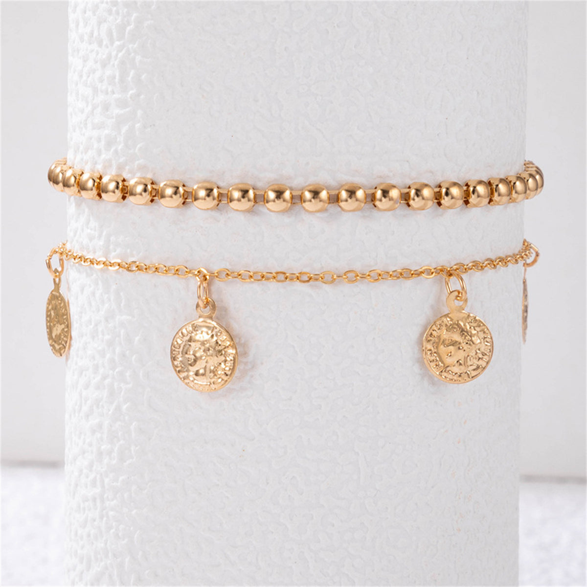 Two stylish gold chain anklets with charms, elegantly designed with an 18K gold-plated coin tassel bead anklet set.
