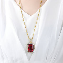 Exquisite red stone pendant with diamond details on a gold chain, combining luxury and style in one stunning necklace.