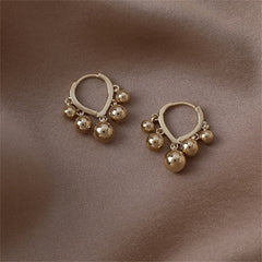 Stunning 18K gold-plated huggie earrings with ball tassels, adding a touch of glamour to your jewelry collection.