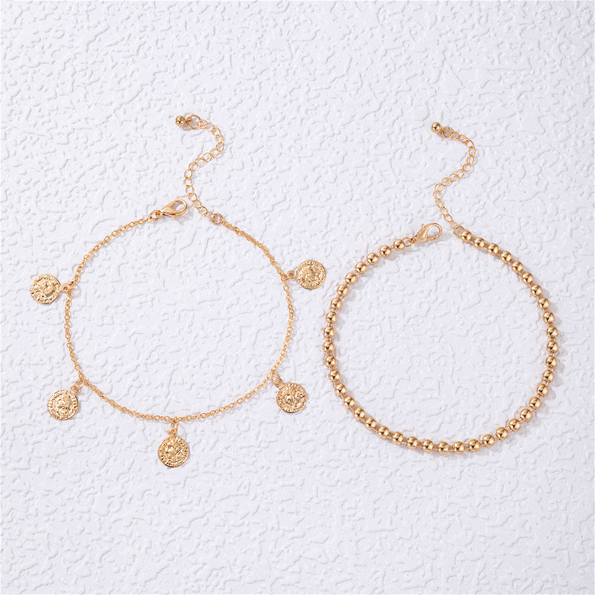 Two beautiful gold chain anklets with charms, highlighted by an 18K gold-plated coin tassel bead anklet set.