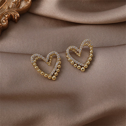 Cubic Zirconia and 18K Gold-Plated Interlocked Openwork Heart Stud Earrings, gold stud earrings for women, detail close-up