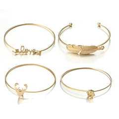 A stunning set of four gold bangles with diverse designs, ideal for festive occasions and holiday gifting.