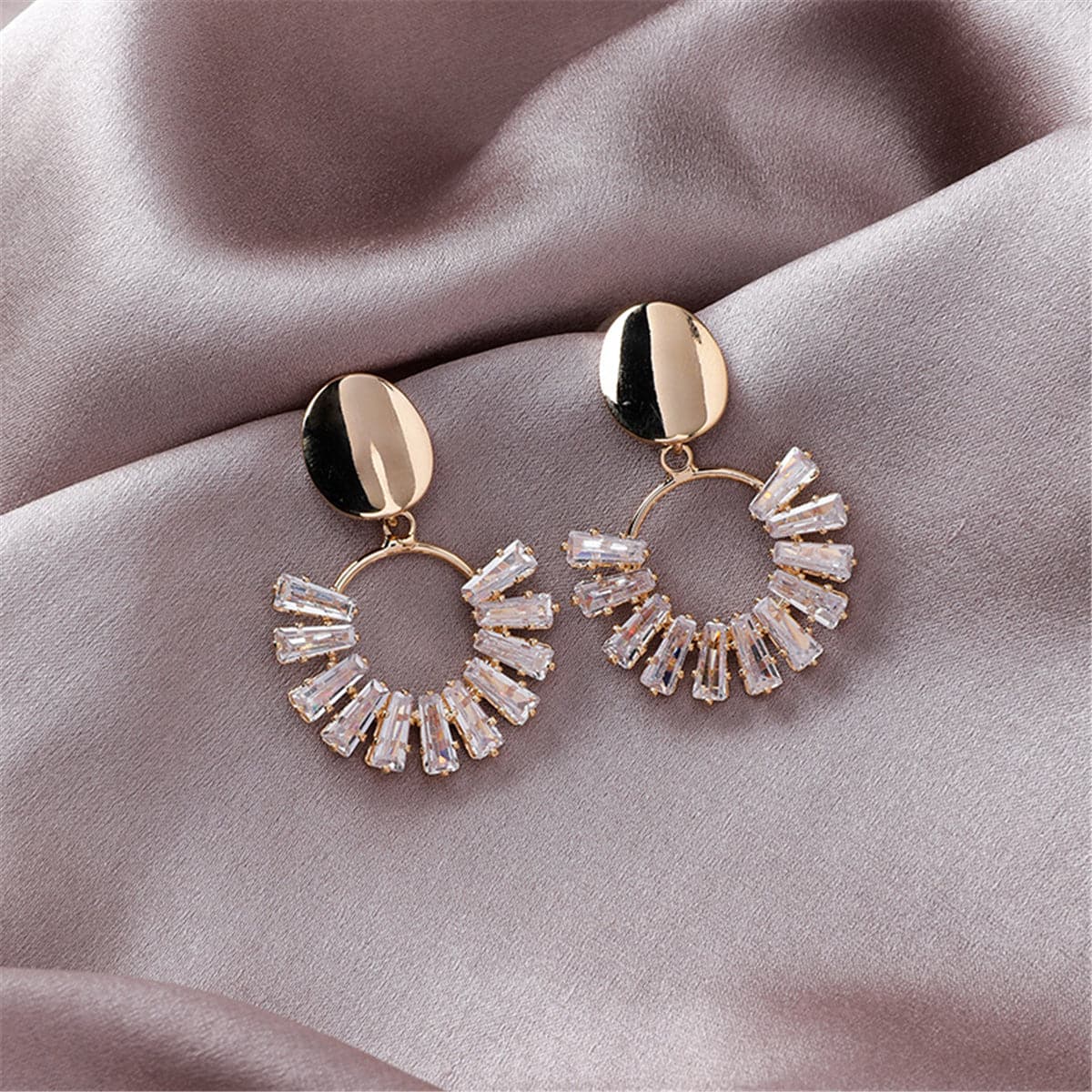 Elegant 18K gold-plated earrings with crystal accents, featuring a stunning circle drop design in gold and white.