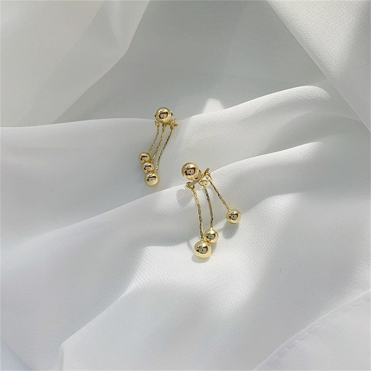18K Gold-Plated Waterfall Ball Tassel Ear Jackets, gold drop earrings for women, botanical inspired, detail close-up