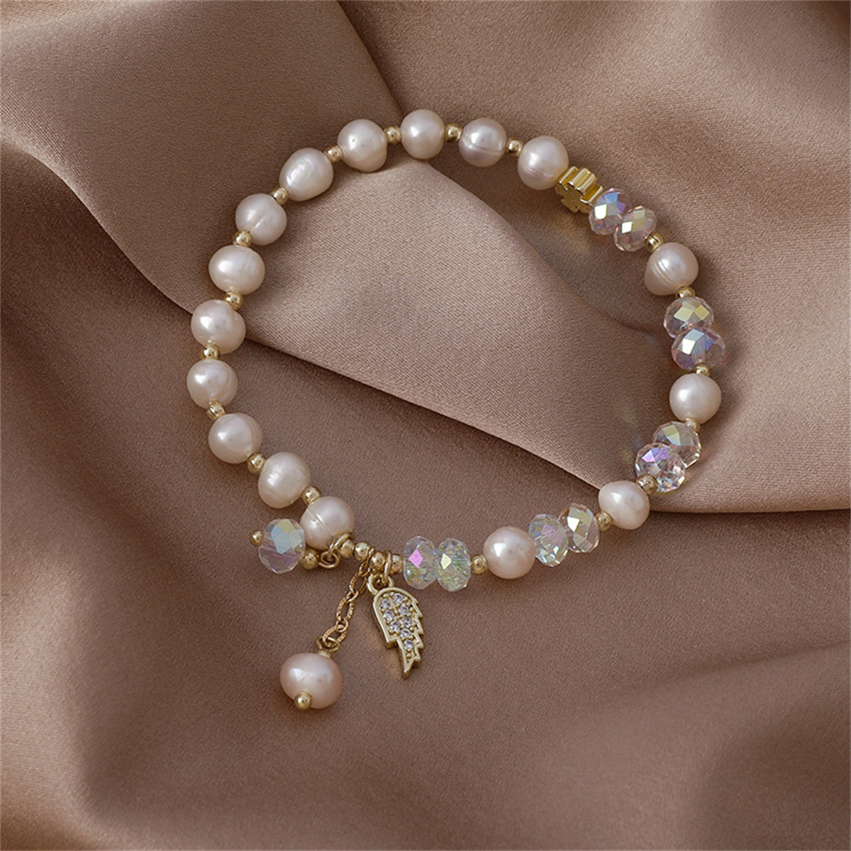 Pearl and Cubic Zirconia 18K Gold-Plated Wing Charm Stretch Bracelet, gold bracelet for women, everyday style, side view