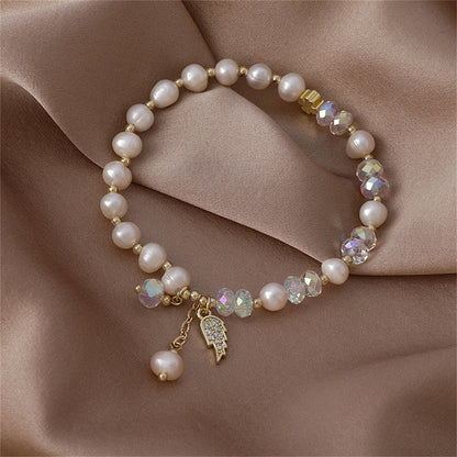 Pearl and Cubic Zirconia 18K Gold-Plated Wing Charm Stretch Bracelet, gold bracelet for women, everyday style, side view