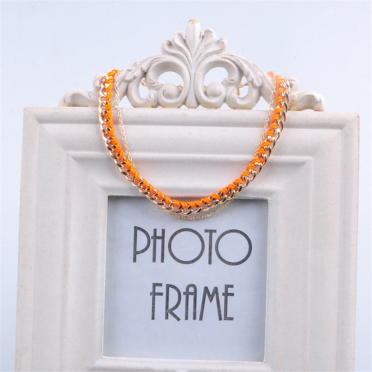 Stunning orange and gold chain anklet, featuring durable polyester and luxurious 18K gold plating for a chic look.