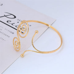 Stylish gold-plated spiral arm cuff showcasing a double swirl design, ideal for elevating your jewelry collection.