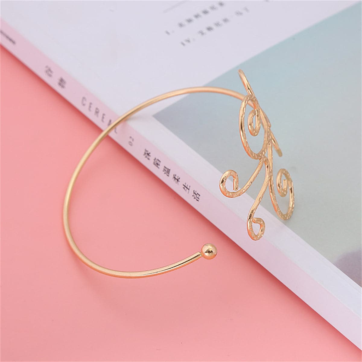Dazzling 18K gold-plated butterfly arm cuff, featuring a spiral design that elevates your style with its unique charm.