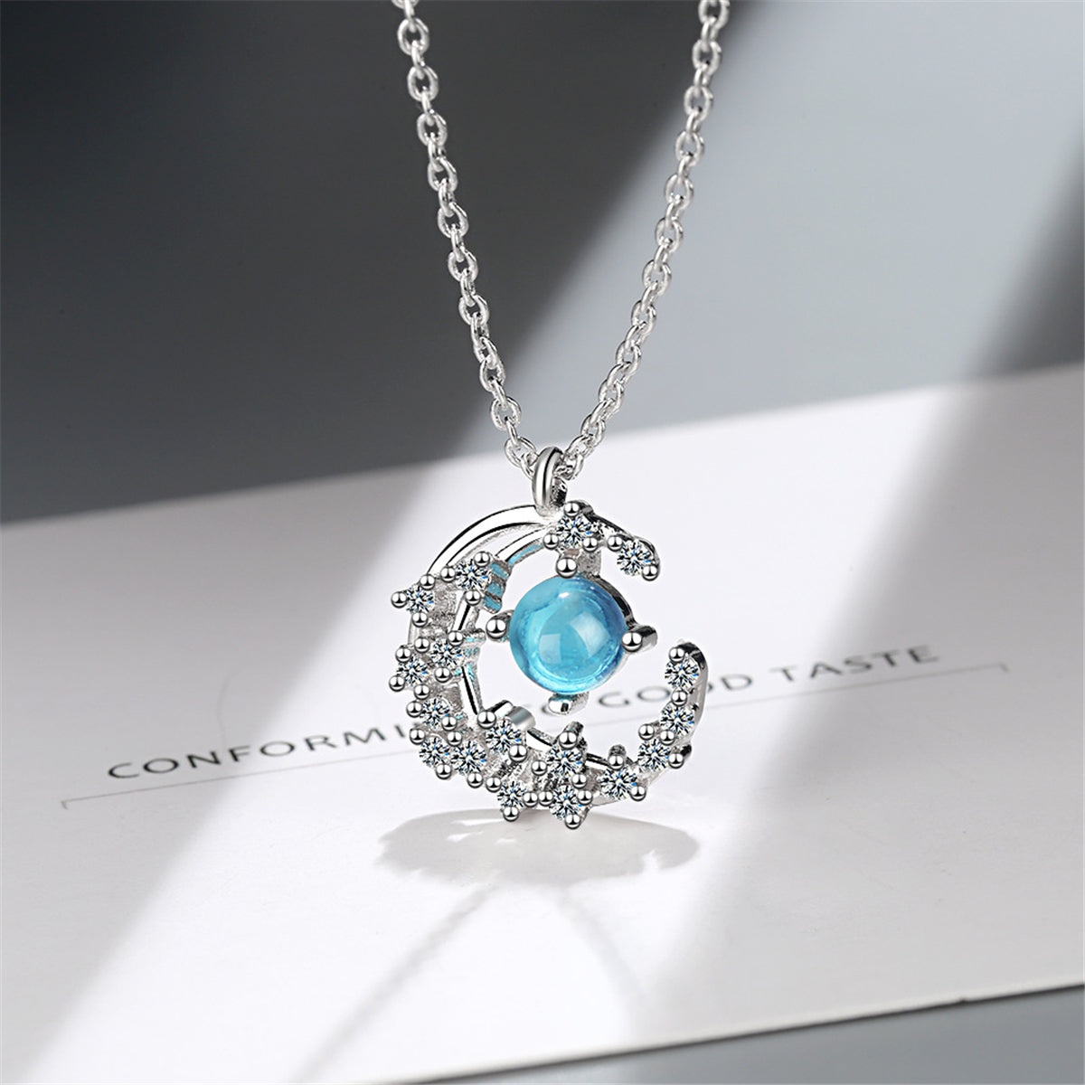 Blue Crystal and Cubic Zirconia Crescent Moon Pendant Necklace, pendant necklace for women, front view