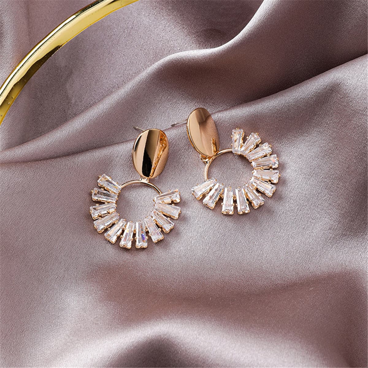 Beautiful 18K gold-plated circle drop earrings embellished with sparkling crystals, showcasing a chic gold and white color scheme.
