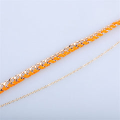 Vibrant orange chain anklet with a gold chain, made from polyester and finished with exquisite 18K gold plating.