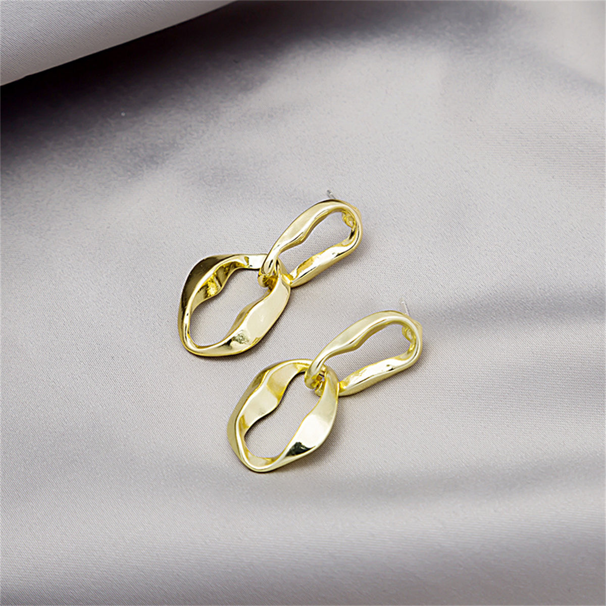 Eye-catching 18K gold-plated earrings with a sophisticated twisted design, perfect for elevating your accessory game.