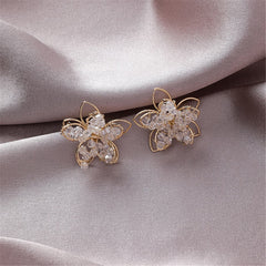 Elegant 18K gold-plated floral stud earrings adorned with clear arylic, perfect for adding a touch of sparkle to any outfit.
