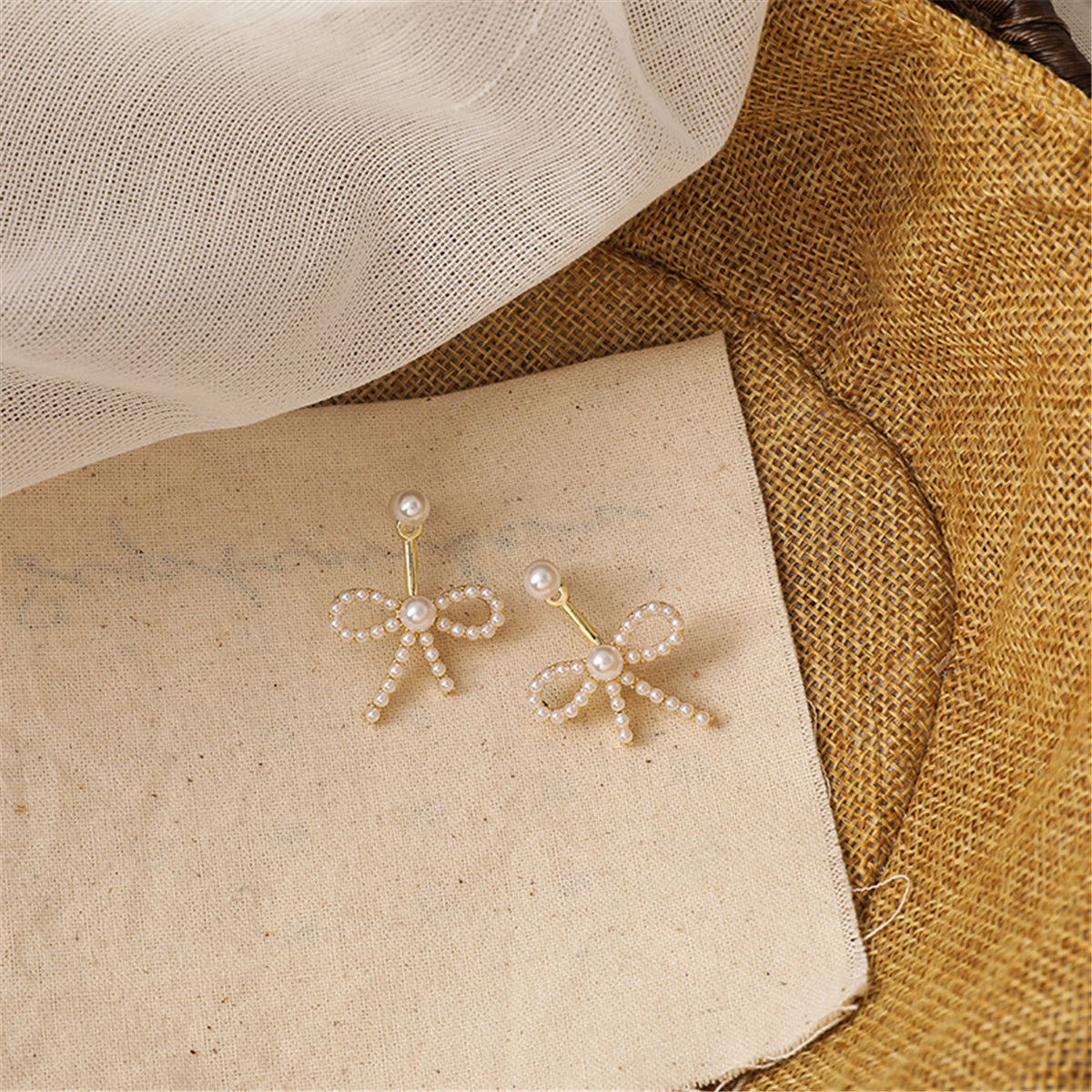 Pearl and 18K Gold-Plated Bow Ear Jackets, gold drop earrings for women, everyday style, detail close-up