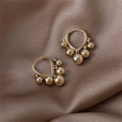 Chic 18K gold-plated hoop earrings adorned with ball tassels, ideal for elevating your everyday style effortlessly.