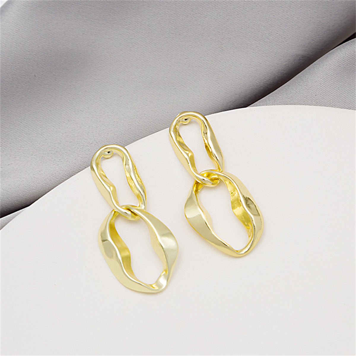 Chic 18K gold-plated abstract earrings featuring a twisted oval design, a must-have for any fashion-forward wardrobe.