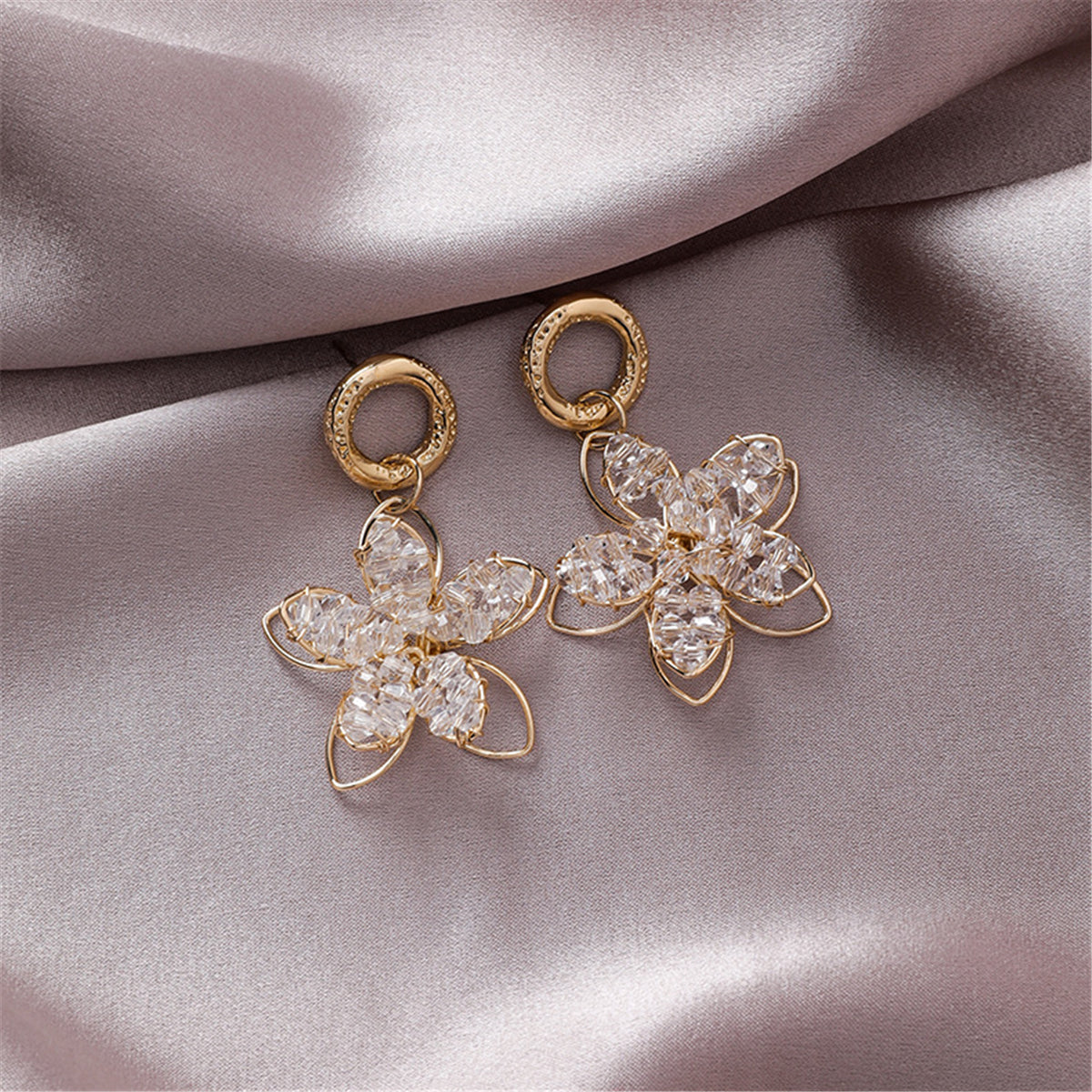 Beautifully crafted 18K gold-plated floral drop earrings with crystal details, ideal for elevating your style effortlessly.