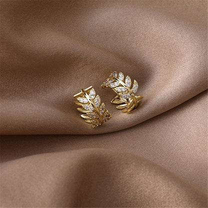 Cubic Zirconia and 18K Gold-Plated Leaf Huggie Earrings, gold huggie earrings, botanical inspired, detail close-up