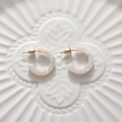 White Acrylic and 18K Gold-Plated Huggie Earrings, gold huggie earrings, dainty minimalist design, lifestyle look