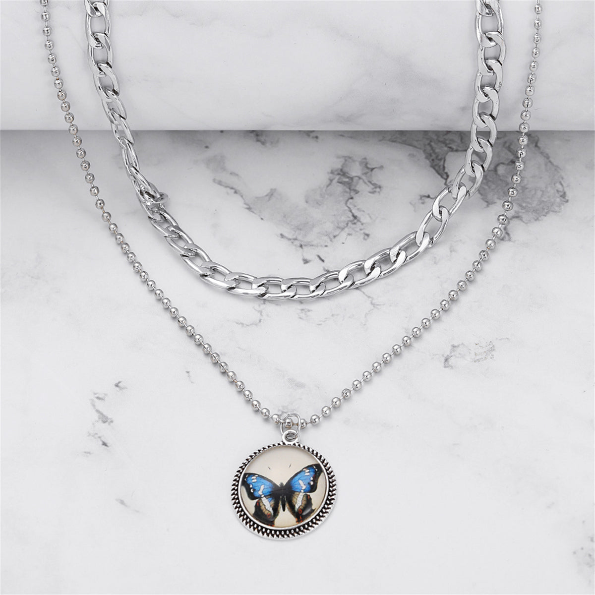 Blue Resin and Silver-Plated Butterfly Round Layered Pendant Necklace, jewelry gift sets for women, detail close-up