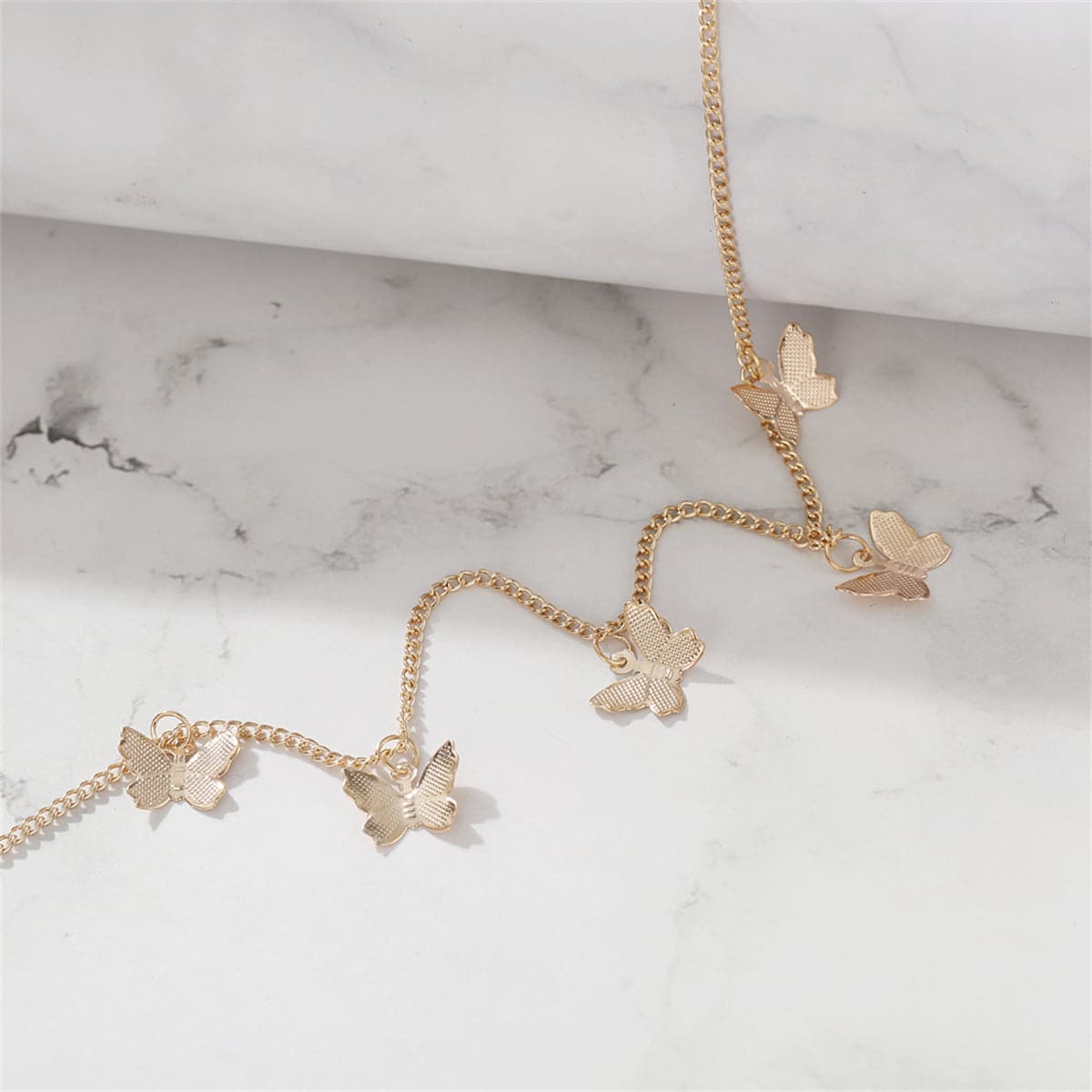 Beautiful 18K gold-plated choker showcasing four small butterflies, a perfect blend of elegance and playful design.