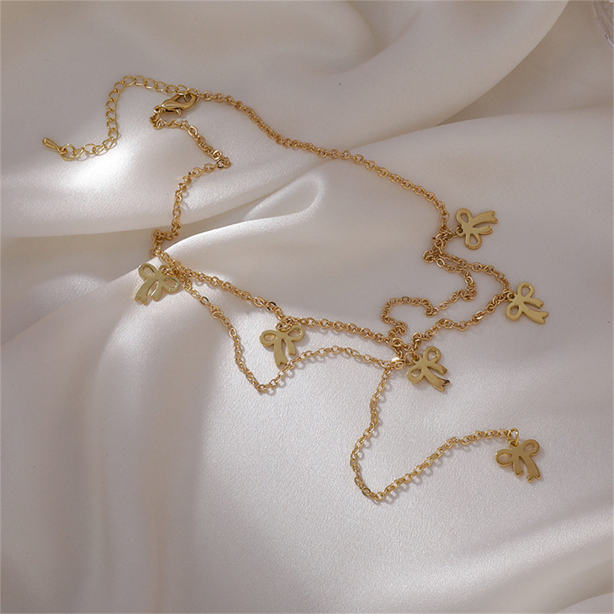 Stunning 18K gold-plated drop choker with bow design, ideal for a chic and meaningful accessory.