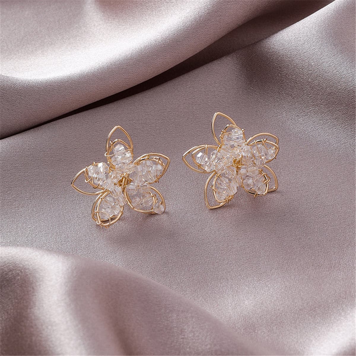 Beautiful 18K gold-plated floral earrings embellished with clear arylic, a must-have accessory for any fashion-forward individual.